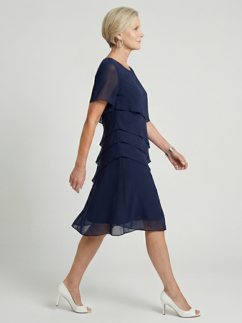 Elegant women's knee-length contour dress with a relaxed fit, round neck, and short sleeves.