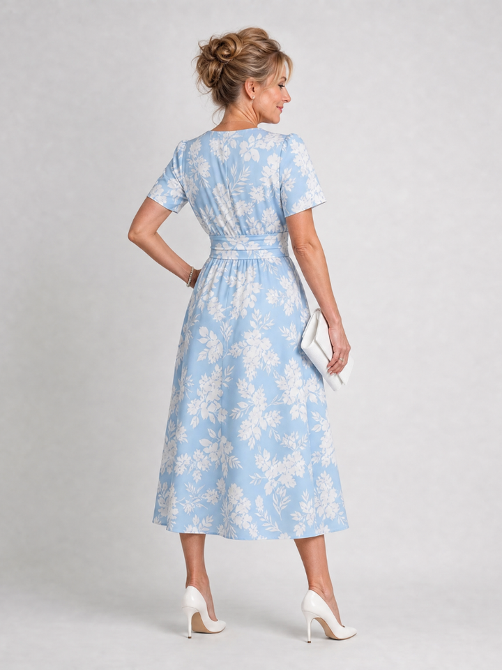 Elegant floral print midi dress for women. Features short sleeves & V-neck, great for casual outings.