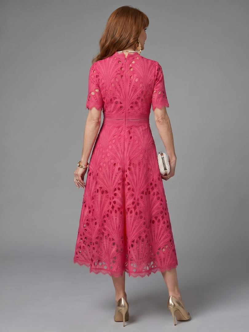 Full shot of a women's elegant pink eyelet lace midi dress, showcasing its flattering silhouette & short sleeves.