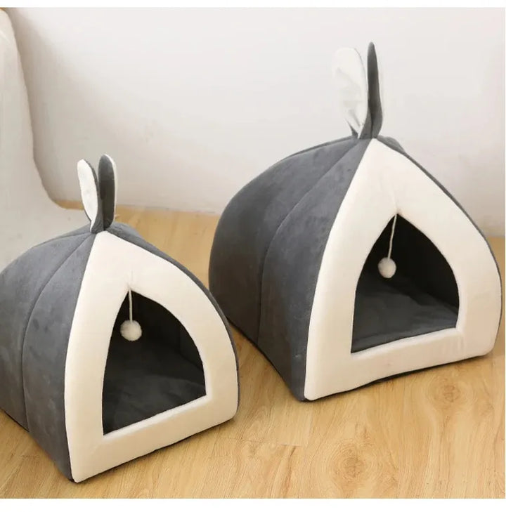 Plush, grey cave cat bed featuring a fun play ball, designed for ultimate feline comfort & play.
