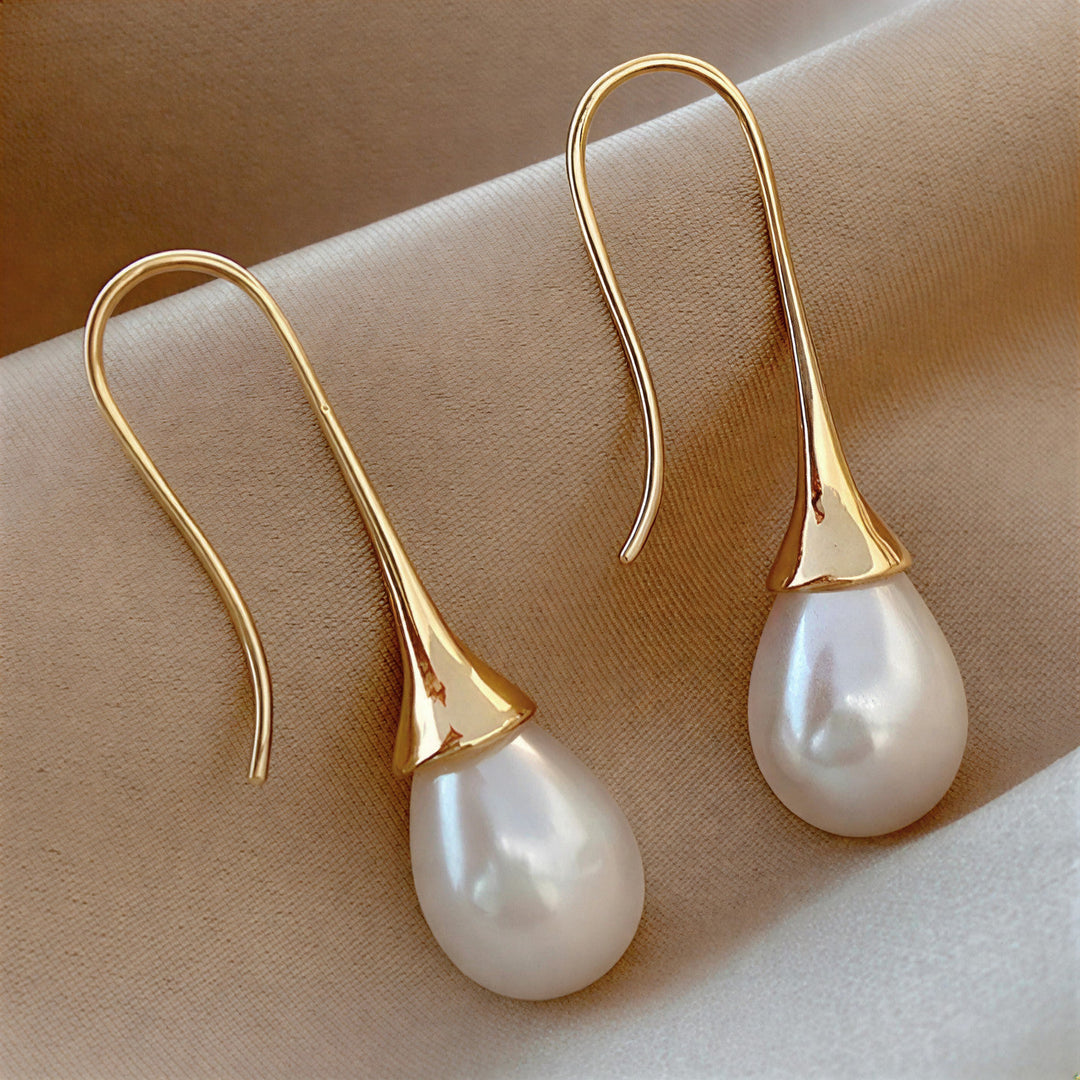 Elegant women's classic pearl drop earrings, timeless jewelry & hypoallergenic fashion accessory.