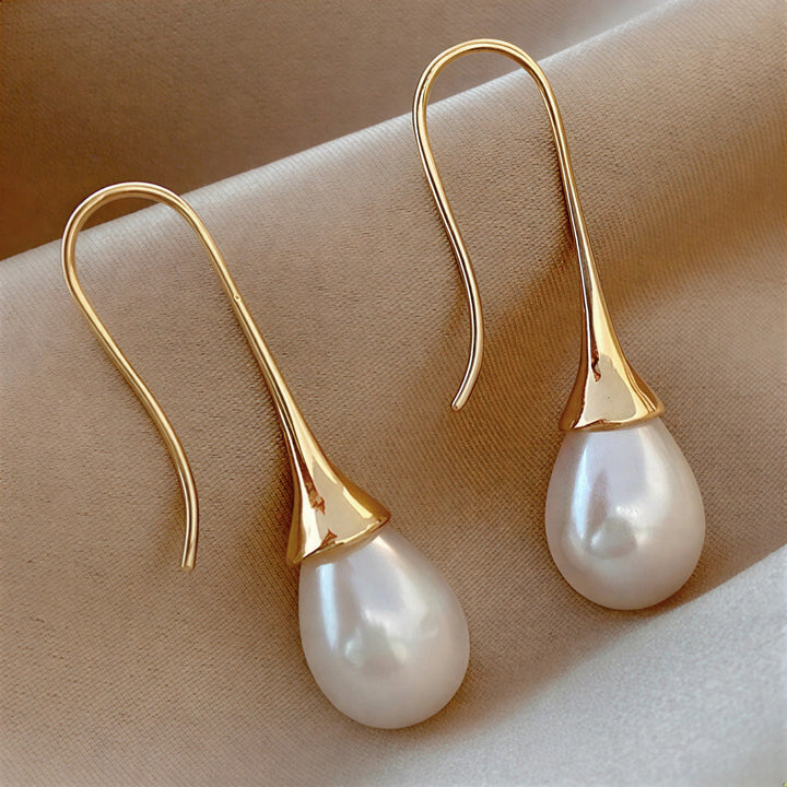 Elegant women's classic pearl drop earrings, timeless jewelry & hypoallergenic fashion accessory.