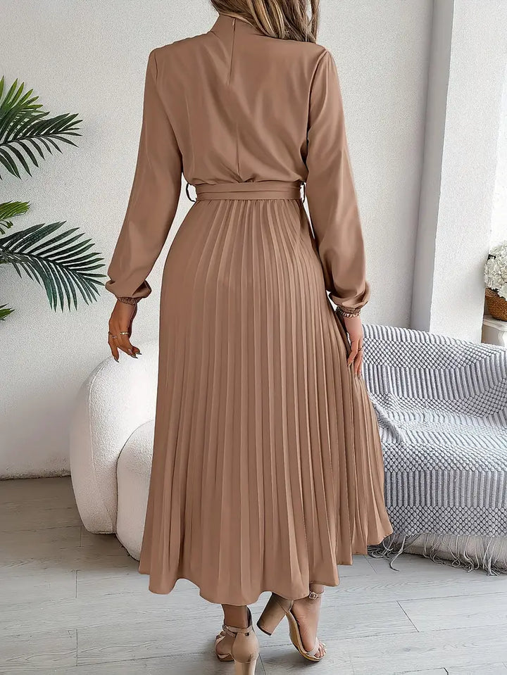 Pleated long-sleeve midi dress for women, sophisticated and belted.