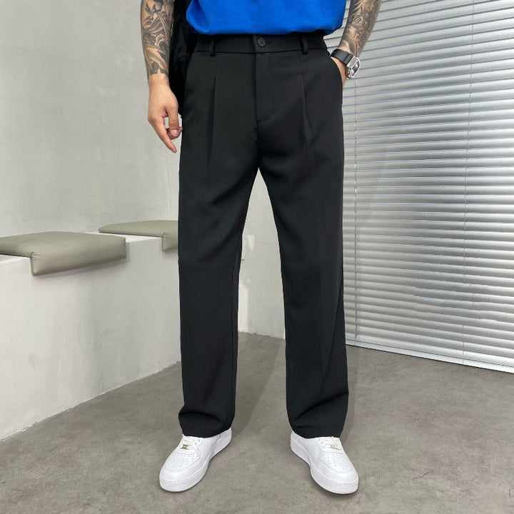 Close-up of men's wide-leg dress trousers, highlighting stylish double pleats & premium fabric texture for contemporary office attire.