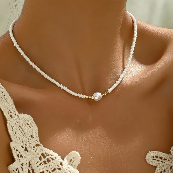 Delicate women's necklace: a small turquoise stone paired with a glowing white pearl. Minimalist design, elegant jewelry.