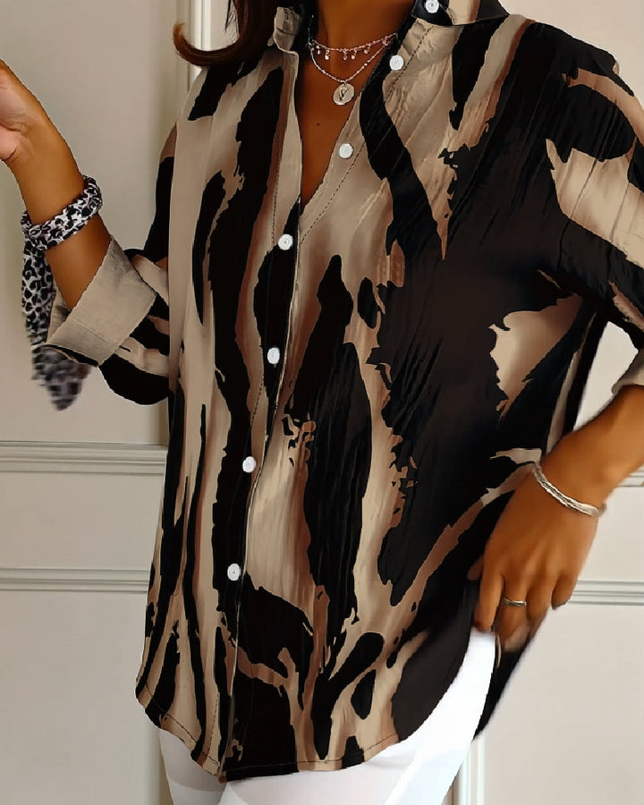 Stylish irregular print women's blouse, stand collar, long sleeve, button details. Casual spring/autumn top.