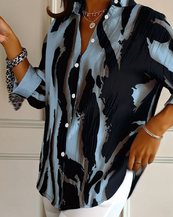 Vibrant irregular print on a women's stand collar long sleeve blouse. Great for spring and autumn casual wear.