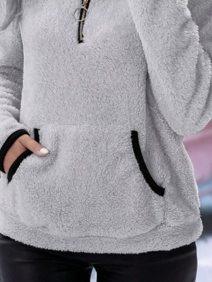 Modern women's half-zip sweater, offering relaxed fit and cozy comfort.