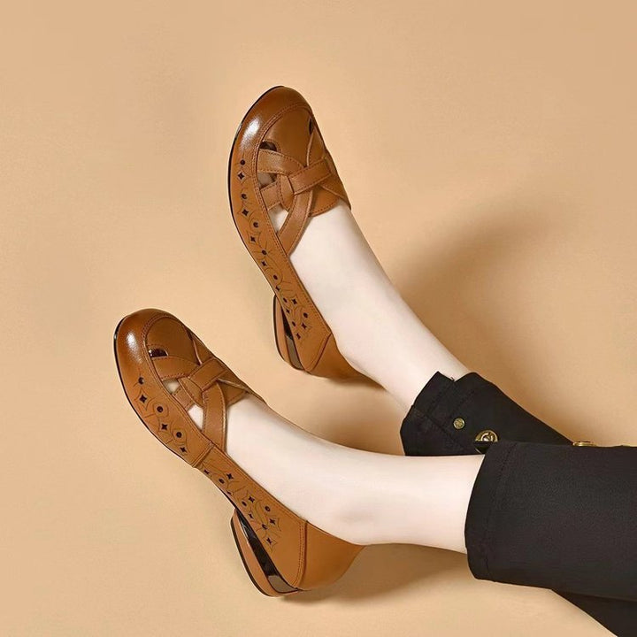 Stylish women's closed-toe slip-on footwear with perforated upper & non-slip sole for comfort.