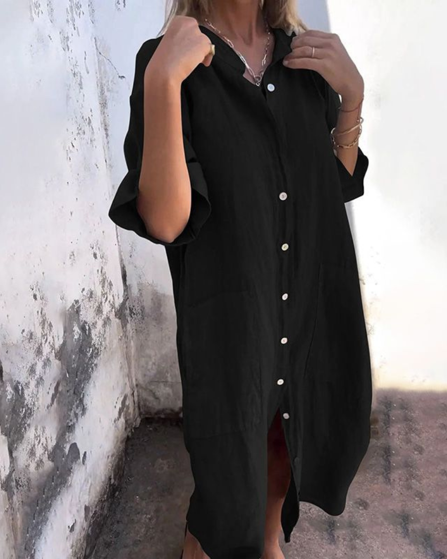 Close-up of a women's shirt dress showing functional button front closure & stylish chest pockets.