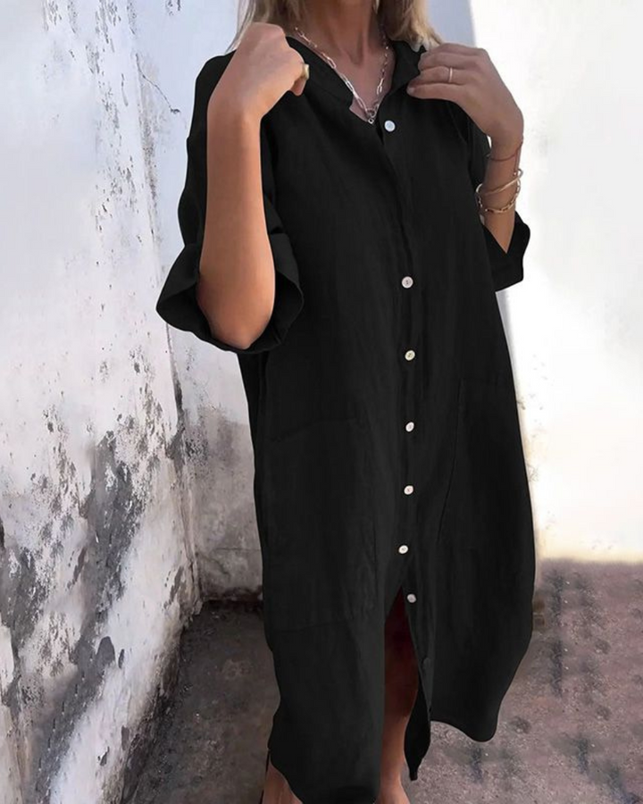 Close-up of a women's shirt dress showing functional button front closure & stylish chest pockets.