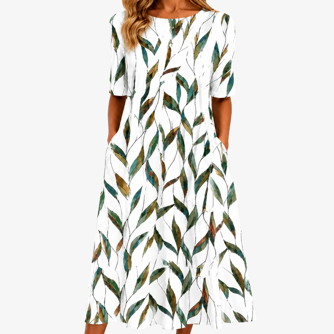 Elegant women's sage green botanical print midi dress with pockets. Perfect A-line floral summer dress for comfort.