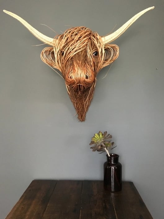 Artisan handwoven rattan Toro wall art, rustic and natural home accent, perfect for boho style.