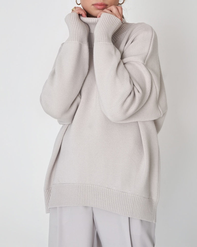 Women's oversized roll neck jumper. Soft, cozy, and stylish for cold weather comfort.