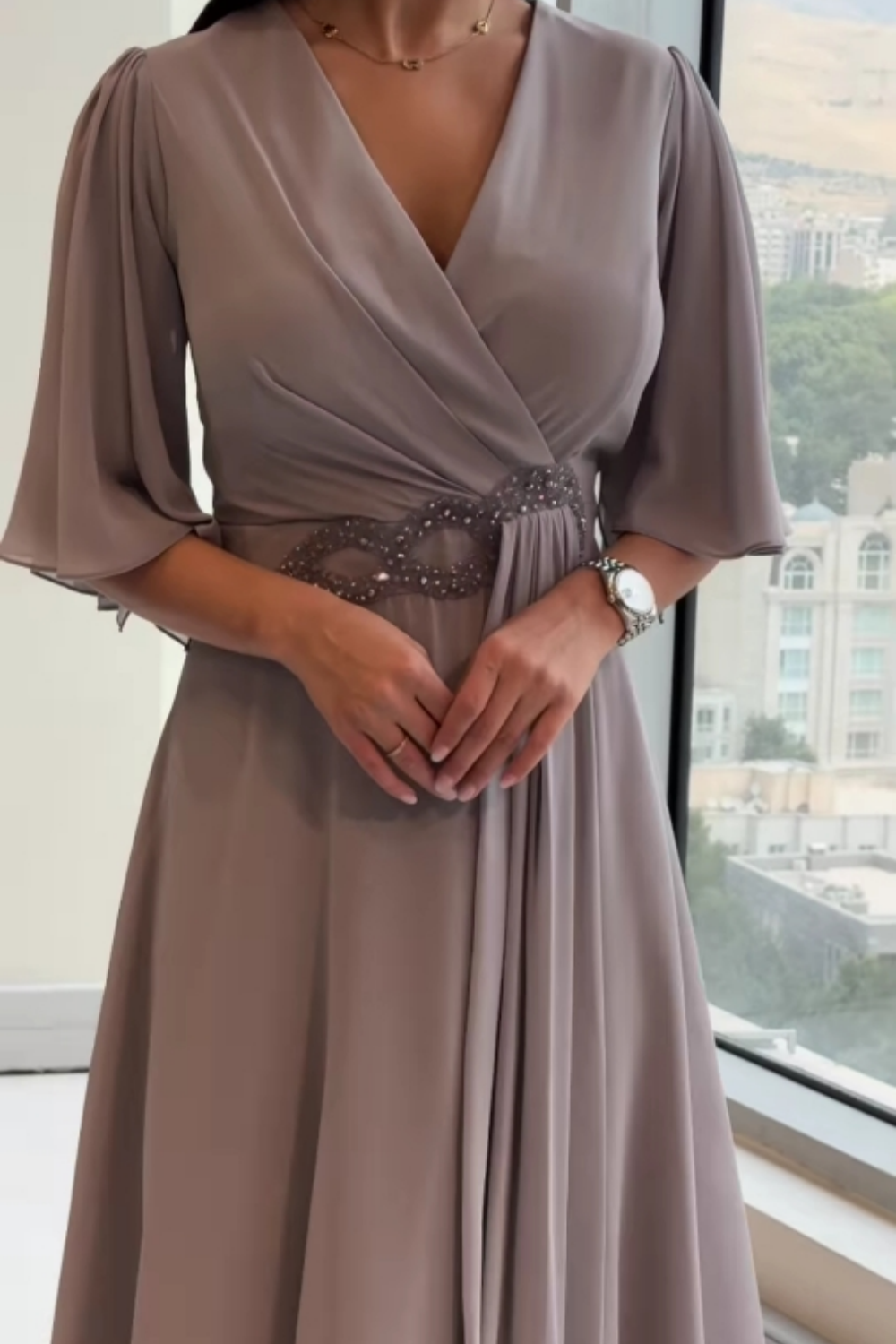 Stylish women's long V-neck party dress. Elegant design suitable for wedding guests & formal events.