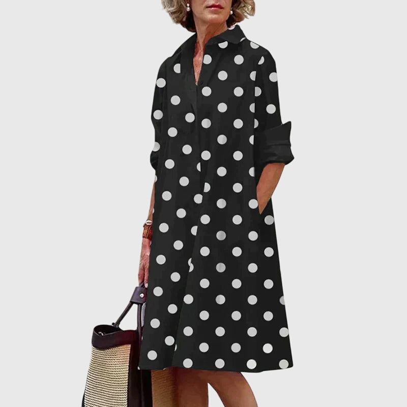 Woman walking, showing the graceful flow of a casual elegant dress with practical pockets.