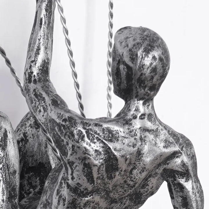 Distinctive climbing figures wall art sculpture set, modern aesthetic.