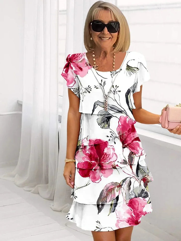 Women's floral tiered mini dress with short sleeves, perfect for casual spring and summer fashion. Flowy & comfortable.