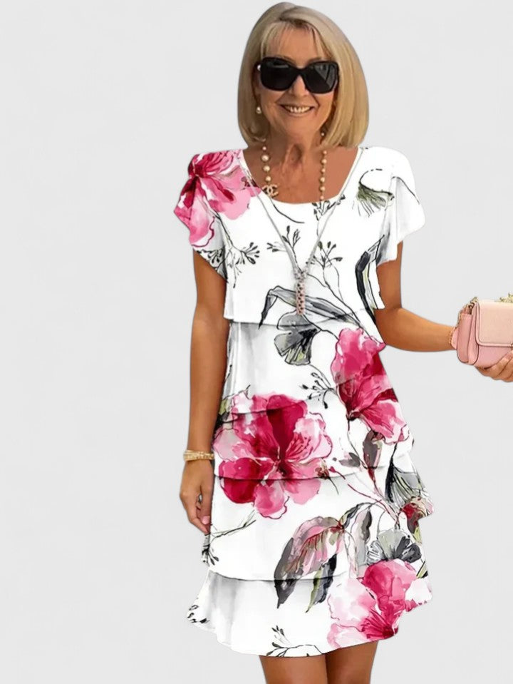 Stylish women's floral short-sleeve midi dress featuring elegant tiered design for summer fashion.