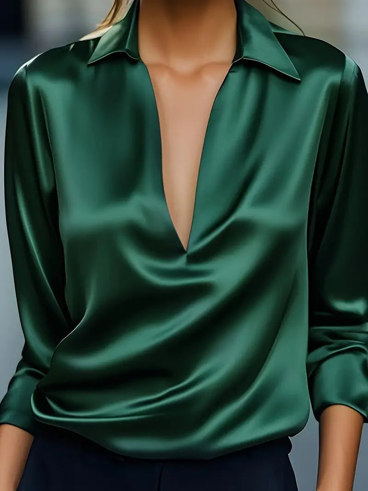 Sophisticated women's V-neck, long sleeve blouse. Collared for a refined, elegant appearance in any setting.