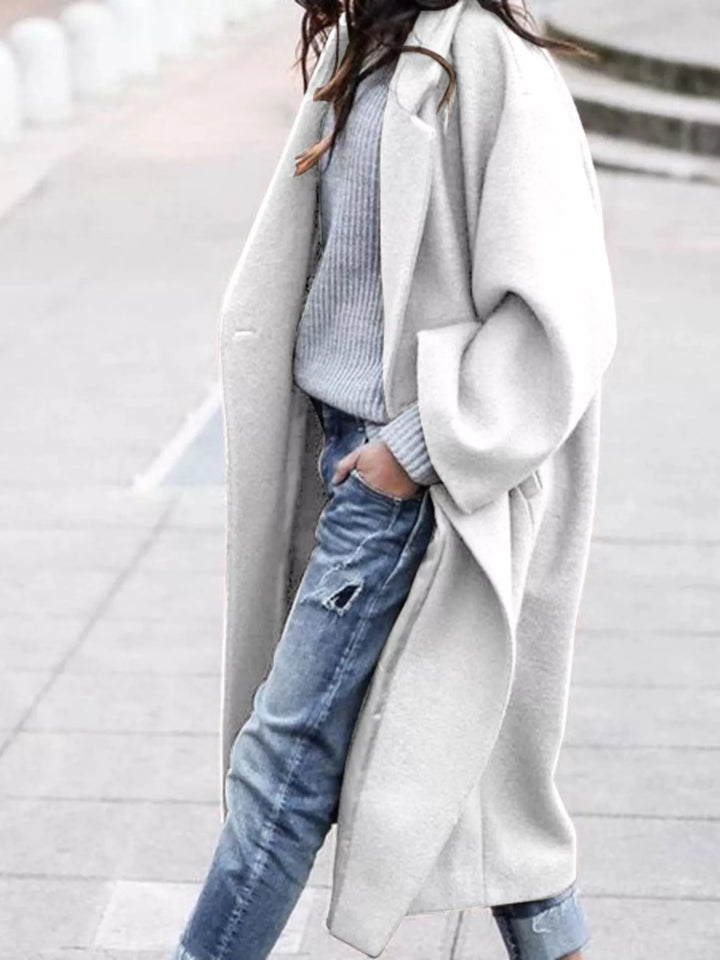 Khaki women's oversized long coat, offering a relaxed fit for fashionable and cozy winter outerwear.