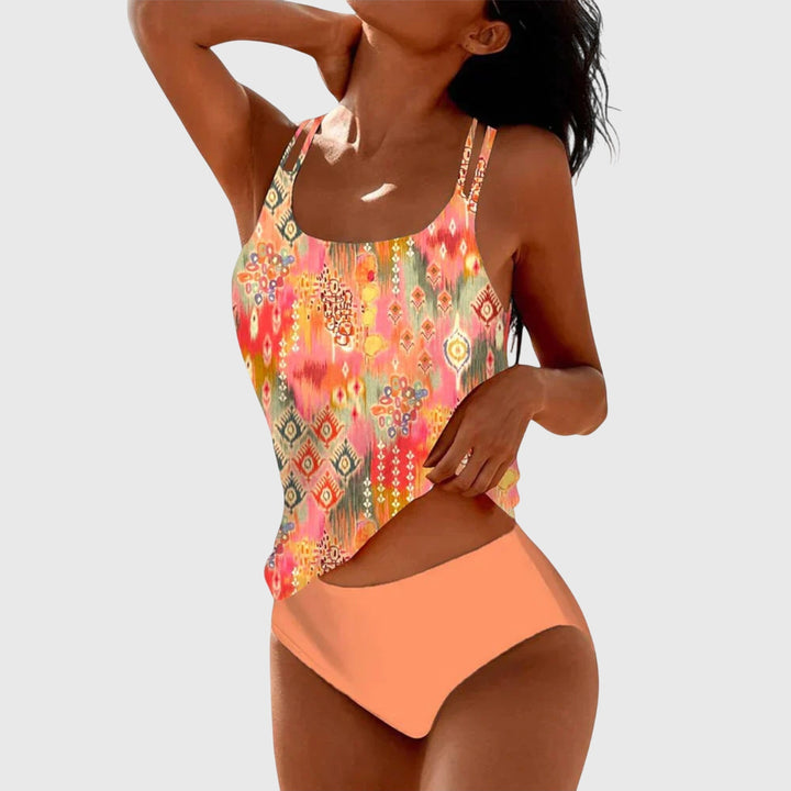 Colorful printed strappy tankini swimsuit, women's vibrant swimwear for resort, pool, and summer beach days.