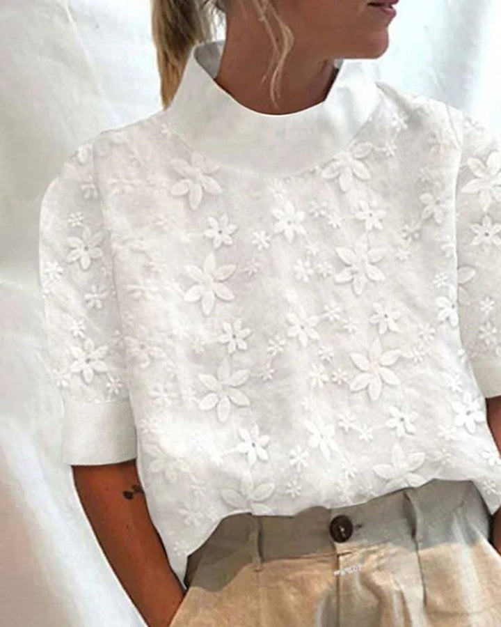 Elegant white women's top with intricate embroidery & stylish stand-up collar. Perfect for chic business casual.