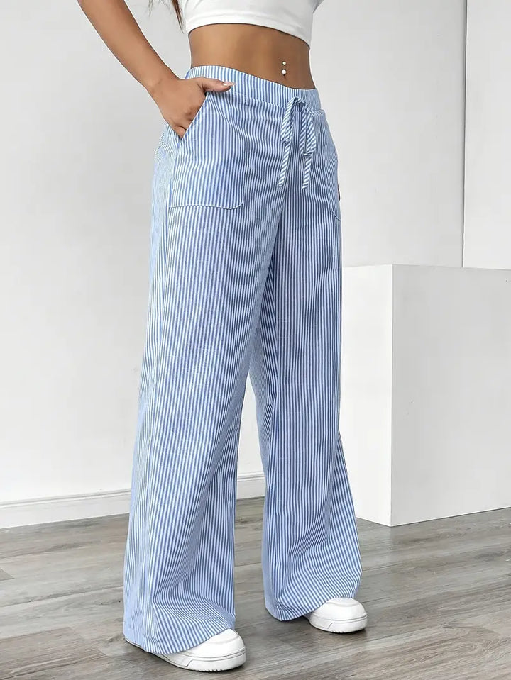 Elegant women's wide leg pants, subtle stripes, flattering fit with pockets.