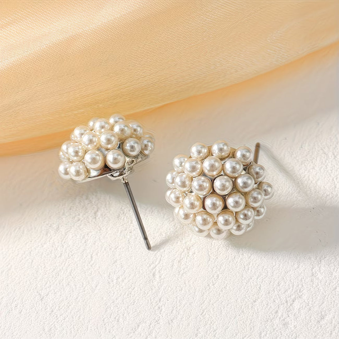 Close-up of elegant pearl dome stud earrings for women. Timeless, hypoallergenic jewelry accessory.