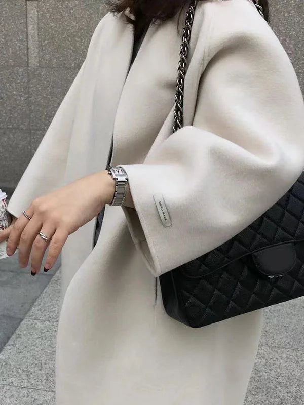 Women's cozy long winter coat, combining elegant design with practical warmth for cold weather.