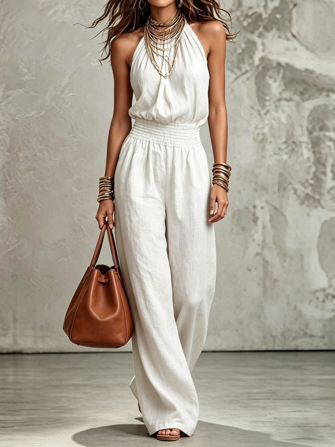 Stylish women's jumpsuit: Halter neck, wide-leg silhouette, and comfortable smocked waist.