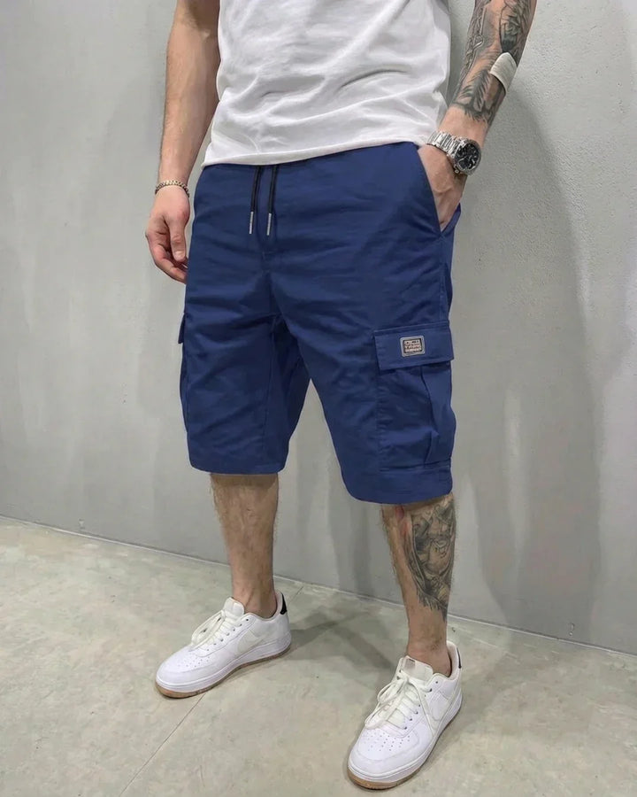 Men's relaxed fit cargo shorts with an adjustable drawstring waist & functional utility pockets, perfect for summer.