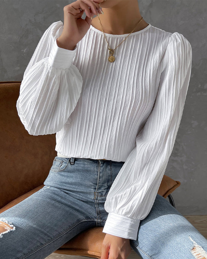 Versatile women's elegant round neck top, ideal for both casual and dressy occasions.