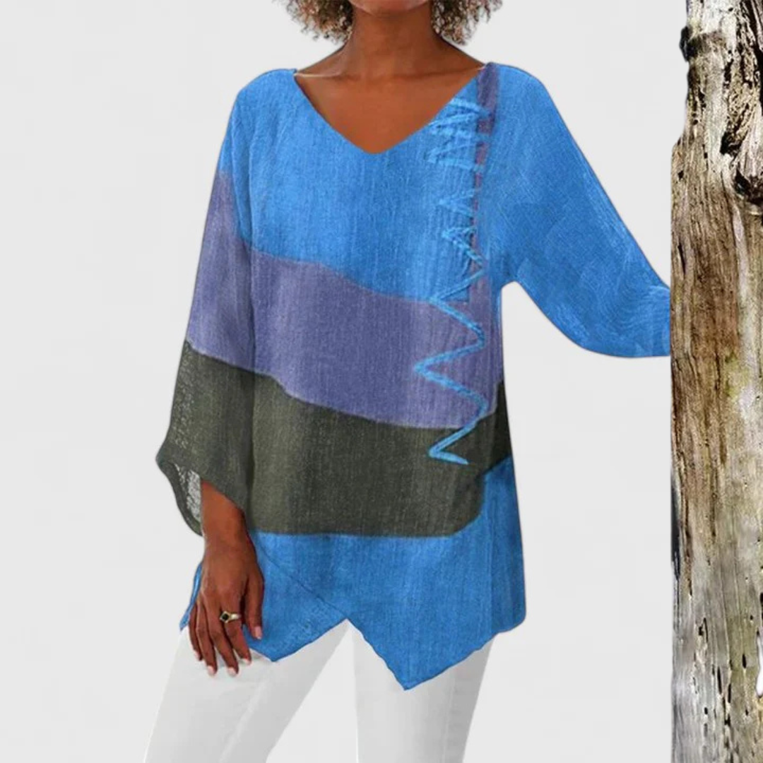 Stylish women's V-neck tunic with an asymmetrical hem and elegant brushstroke pattern, a versatile spring/summer fashion top.