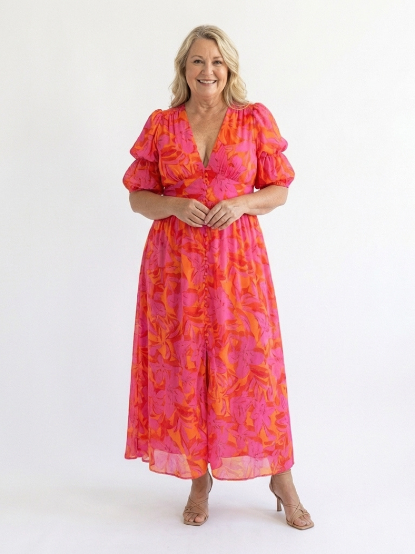 Flowy women's pink floral midi dress, featuring a flattering V-neck and elegant puff sleeves, perfect for movement.