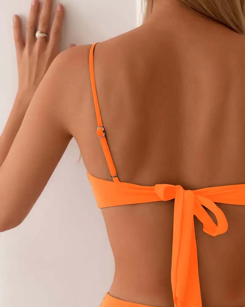 Women's two-piece bikini set, elegant and stylish with gold accents, ideal for summer swimwear.