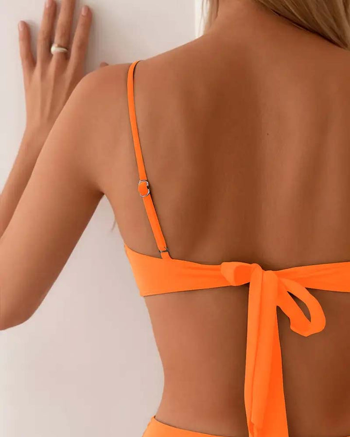 Women's two-piece bikini set, elegant and stylish with gold accents, ideal for summer swimwear.