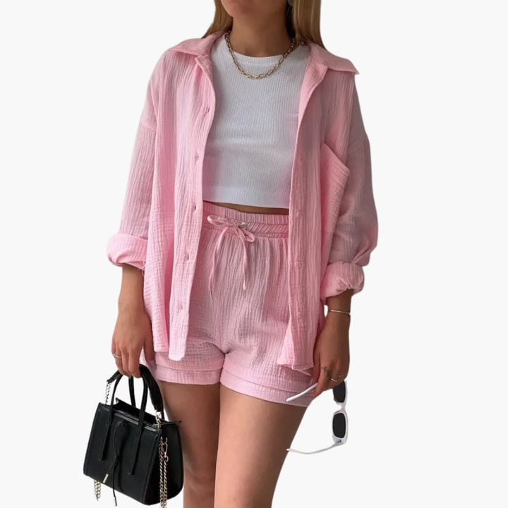 Women's trendy three-piece outfit: elegant button shirt, chic crop top & high-waisted shorts for summer.