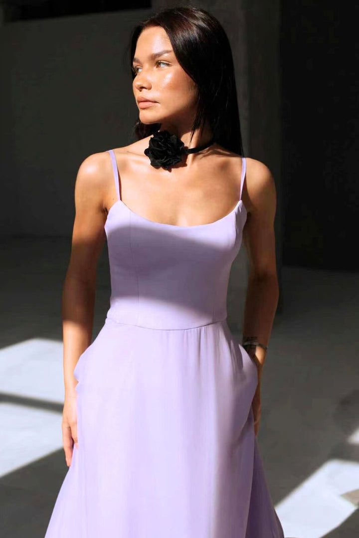 Stylish women's elegant flowing midi dress in a vibrant color, ideal formal wear for summer weddings & parties.