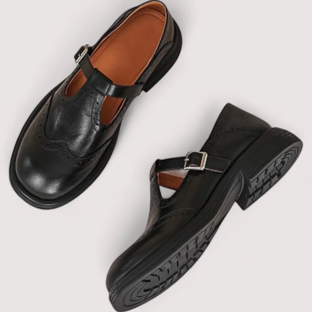 Vintage style brown Mary Jane shoes for women, featuring intricate brogue details & a comfortable strap.