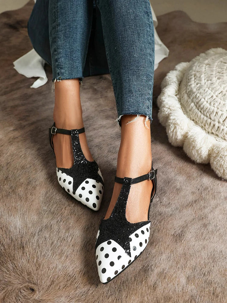 Close-up of elegant women's patterned T-bar ballet flats. Shows the unique polka dot design & quality craftsmanship.