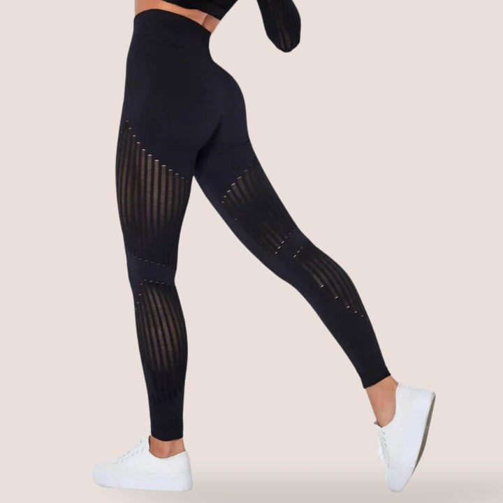Woman exercising in high-waist slimming leggings, anti-cellulite activewear for effective workout.