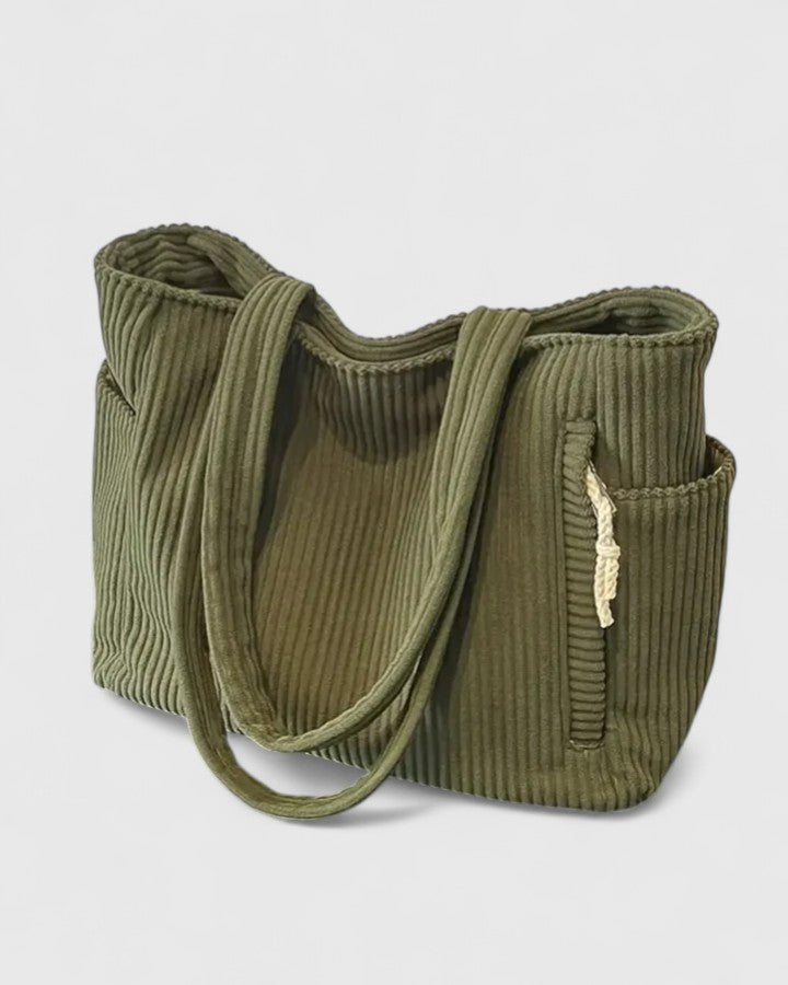 Woman carrying a stylish corduroy tote bag, a perfect everyday shoulder bag for any outfit.