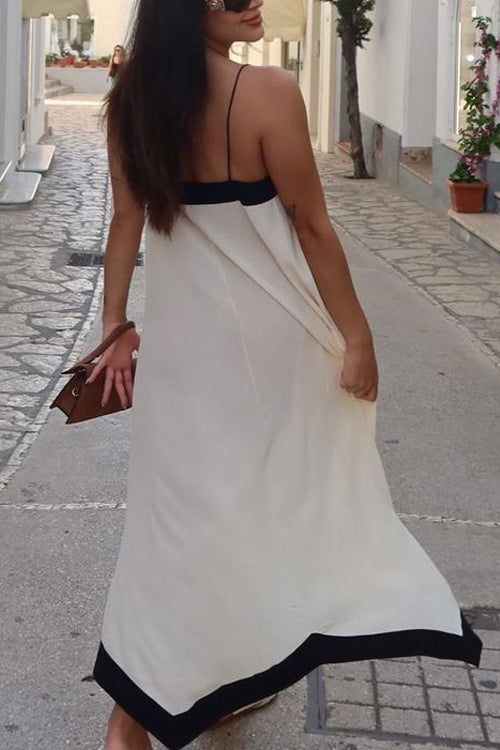 Beautiful women's white V-neck spaghetti strap maxi dress. Ideal beachwear, vacation dress, or elegant summer outfit.