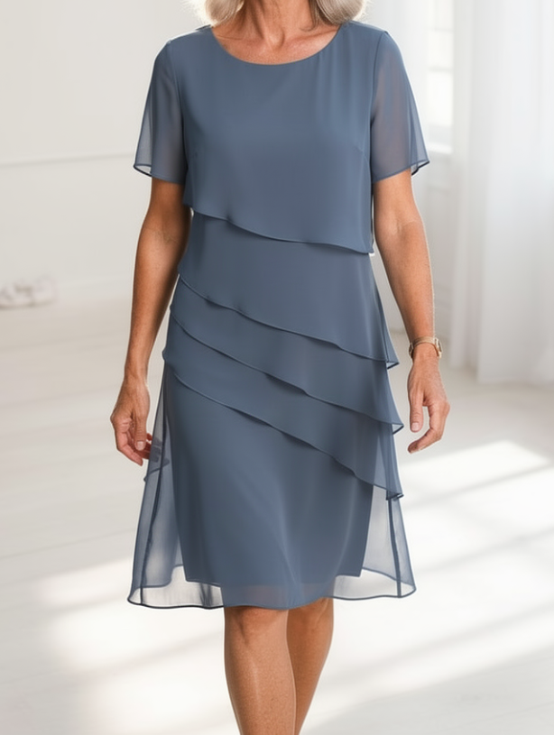 Chic women's ruffled midi dress with a beautiful flowing silhouette, ideal for elegant spring/summer fashion.