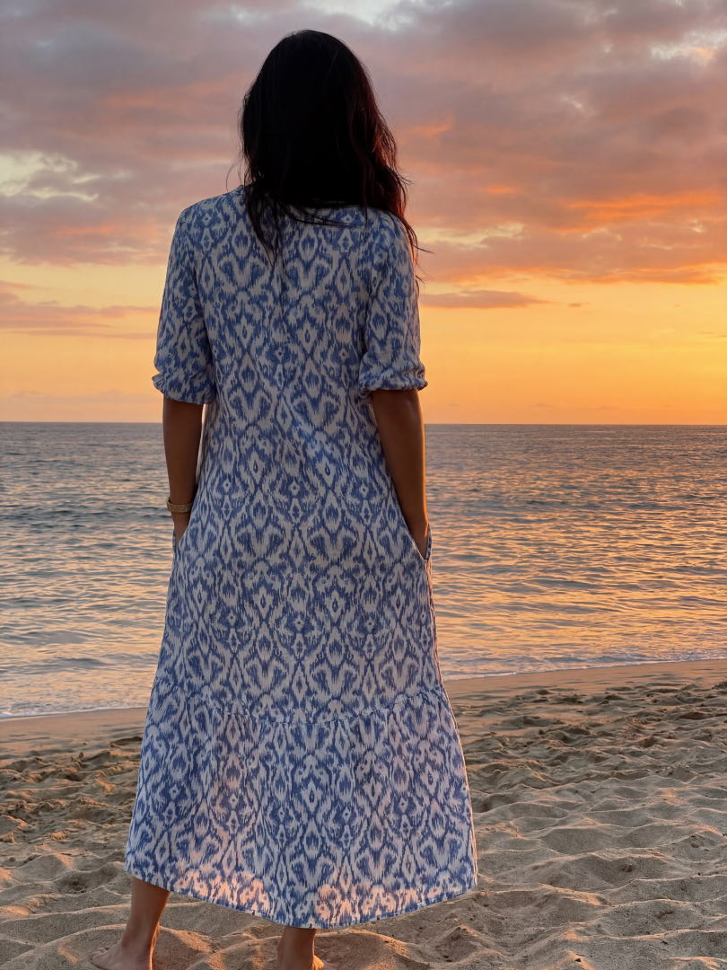 Vacation-ready women's coastal midi dress. Eye-catching geometric pattern, short sleeve, V-neck, perfect for summer travel.