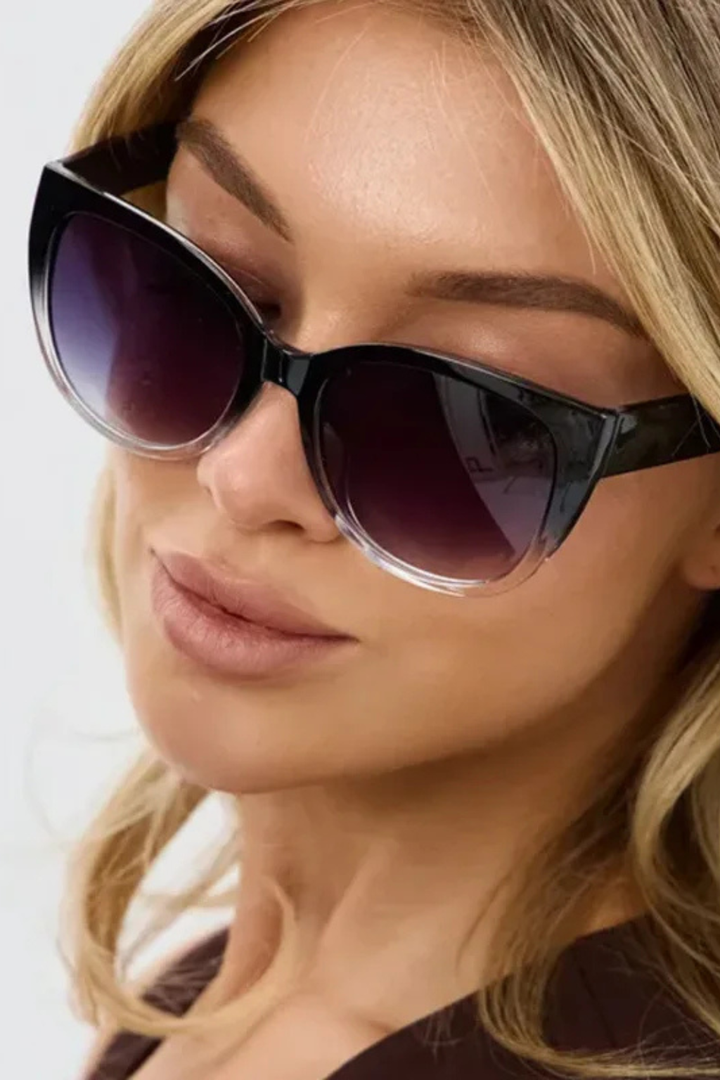 Women's black oversized cat eye sunglasses with a chic gradient frame, stylish fashion eyewear accessory.
