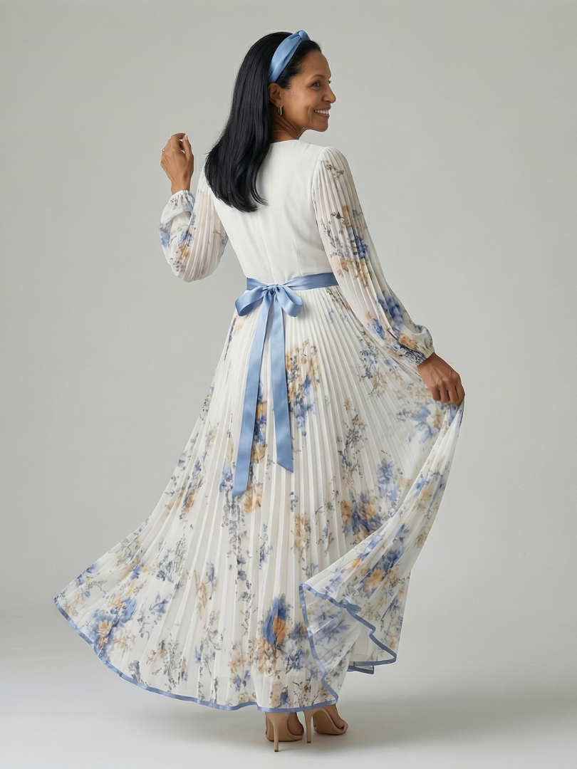 Stylish women's white midi dress with elegant pleats, a wrap design, long sleeves, and a delicate floral pattern, for special events.