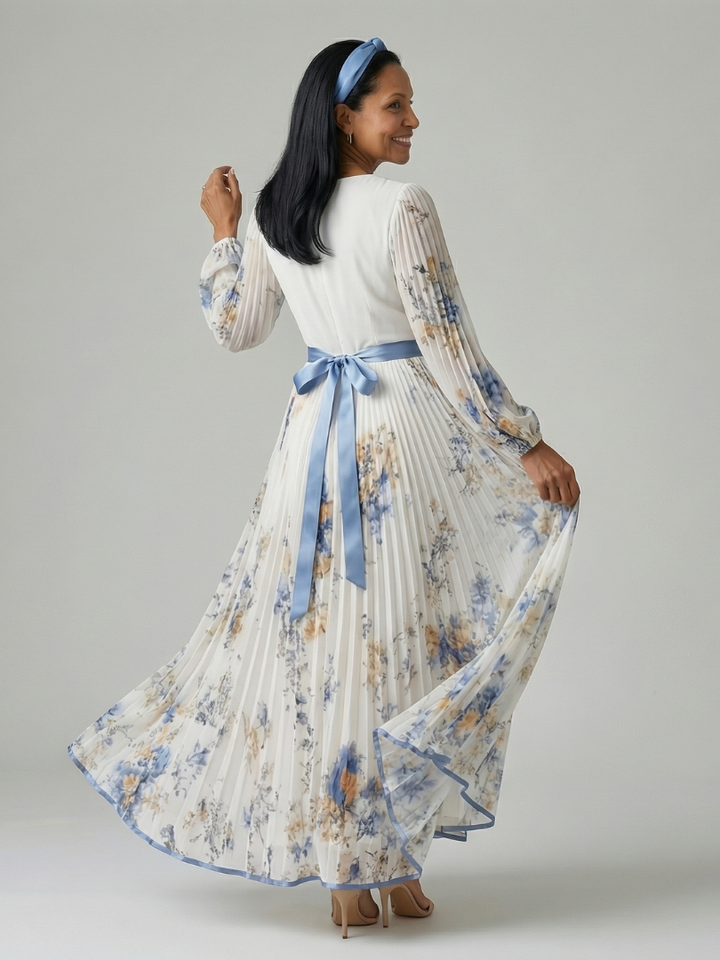 Stylish women's white midi dress with elegant pleats, a wrap design, long sleeves, and a delicate floral pattern, for special events.