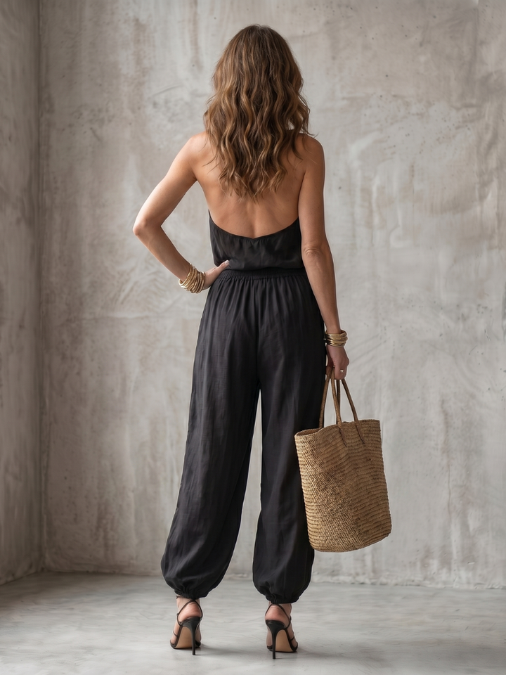Elegant two-piece black set for women: sleeveless drape neck top & comfortable wide leg pants.